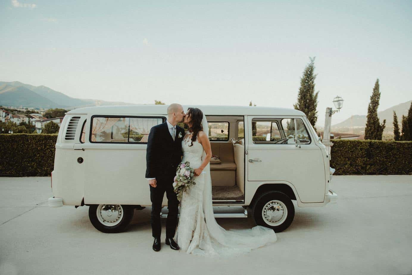 couple kissing beside white Volkswagen T2